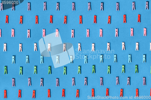 Image of Clothespins colored on a blue background.