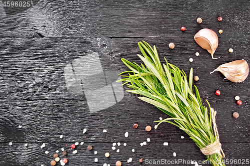 Image of Frame of rosemary and garlic on black board top