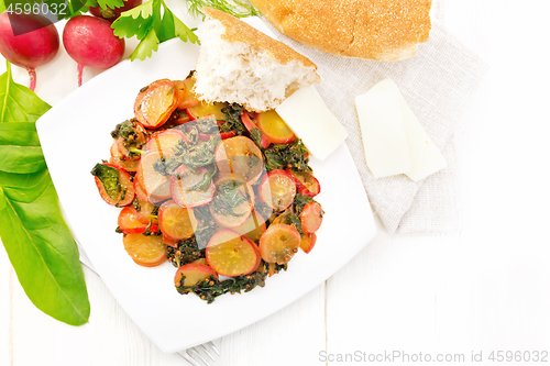 Image of Radish with spinach and spices in plate on board top