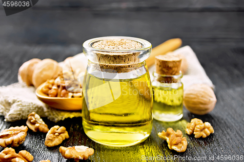 Image of Oil walnut in jar with spoon on board