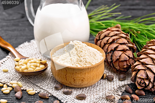 Image of Flour cedar in bowl with nuts on board