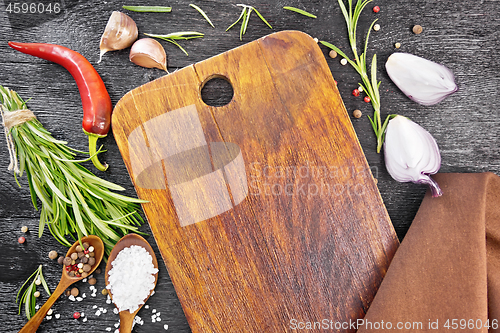 Image of Frame of salt and herbs with plate on black board top