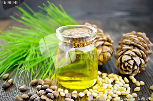 Image of Oil cedar in glass jar on dark board