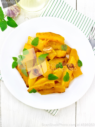 Image of Pumpkin with garlic in plate on light board top