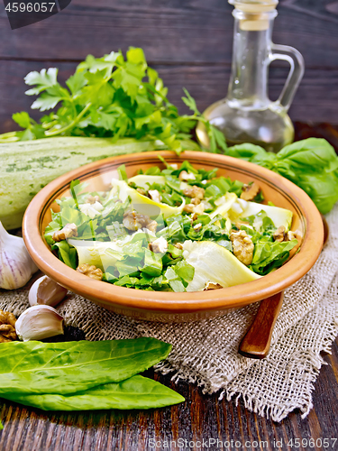 Image of Salad with squash and sorrel in plate on board