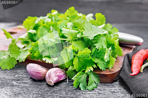 Image of Cilantro fresh with garlic on black board