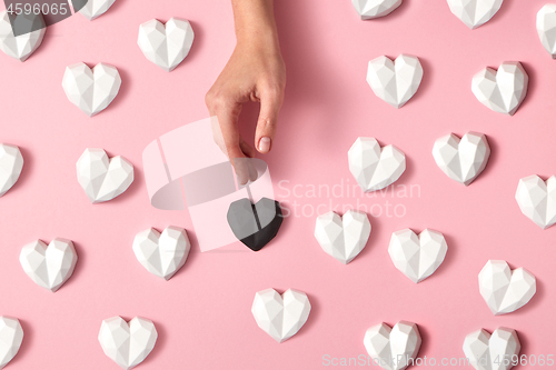 Image of Gypsum hearts pattern with woman\'s hand.