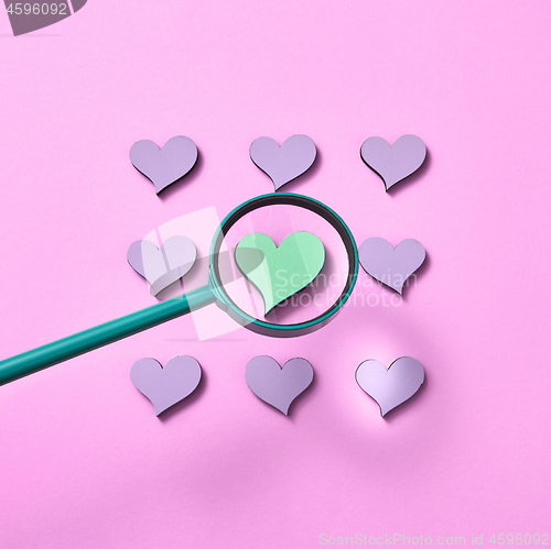 Image of Square heart pattern with magnifying glass above.