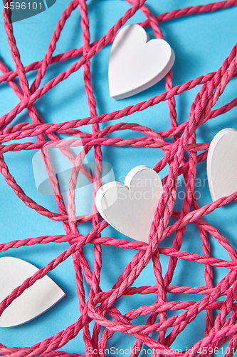 Image of Valentine\'s card with red rope and white hearts.