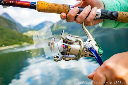 Image of Woman fishing on Fishing rod spinning in Norway.