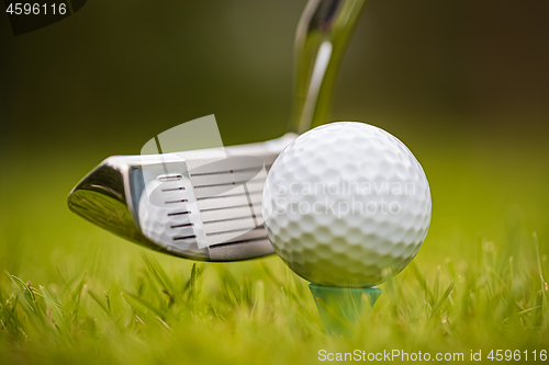 Image of Golf ball on tee in front of driver