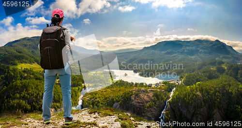 Image of Hiker woman standing on top of the mountain. Beautiful Nature No