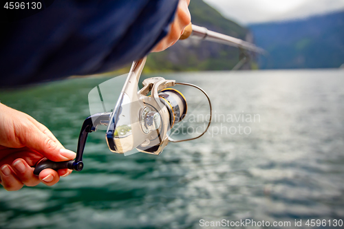 Image of Woman fishing on Fishing rod spinning in Norway.