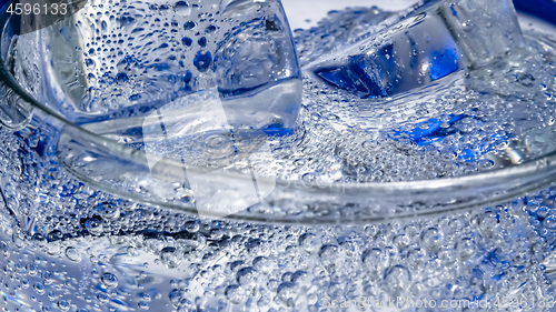 Image of Glass of water with ice on a dark blue background