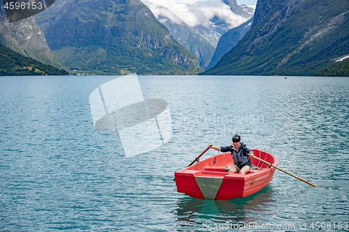 Image of Woman fishing on a boat.