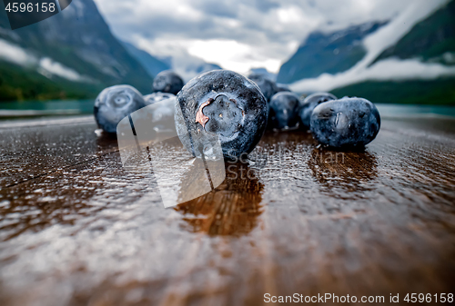 Image of Blueberry antioxidants on a wooden table on a background of Norw