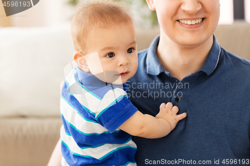 Image of happy baby son with father at home