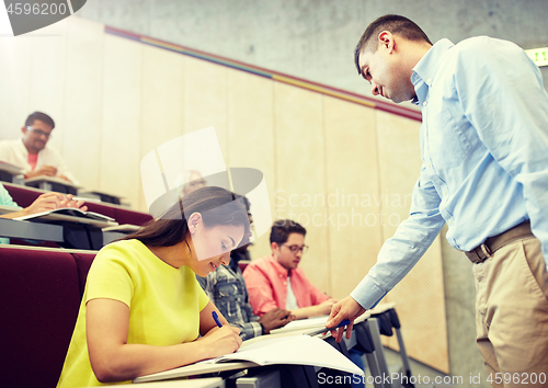 Image of group of students and teacher with notebook