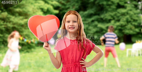 Image of smiling red haired girl with heart shaped balloon