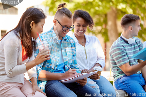 Image of group of happy students with notebook and drinks