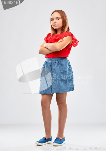 Image of displeased girl with crossed arms over grey