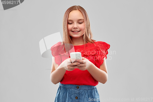 Image of beautiful smiling girl using smartphone