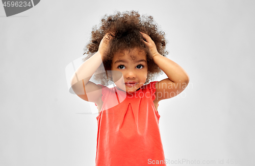 Image of overwhelmed african american girl holding to head