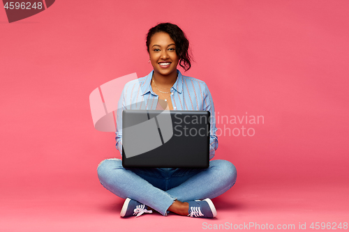 Image of happy african american woman with laptop computer