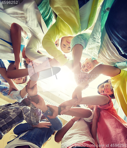 Image of group of international students holding hands