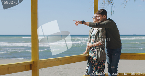 Image of Couple chating and having fun at beach bar