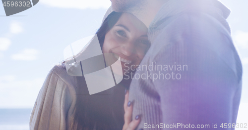 Image of Couple having fun on beautiful autumn day at beach