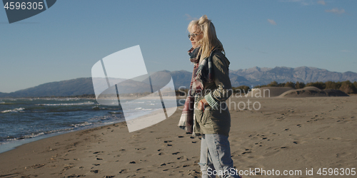 Image of Young woman enjoying the warm autumn day