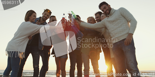 Image of Friends on beach party drinking beer and having fun