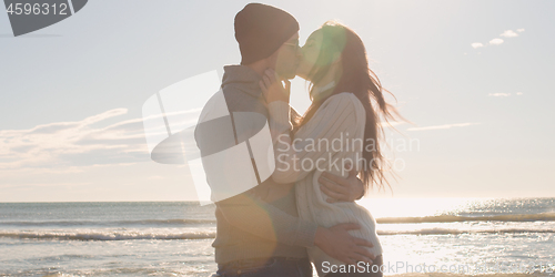 Image of Couple having fun on beautiful autumn day at beach