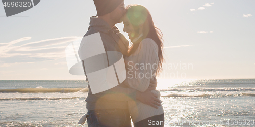 Image of Couple having fun on beautiful autumn day at beach