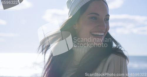 Image of Girl In Autumn Clothes Smiling on beach