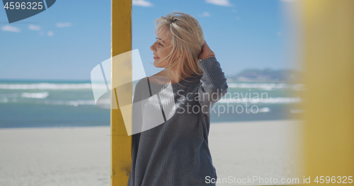 Image of Young woman enjoying the warm autumn day