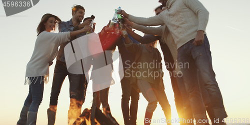 Image of Friends on beach party drinking beer and having fun