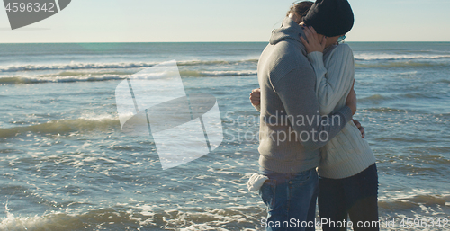 Image of Couple having fun on beautiful autumn day at beach