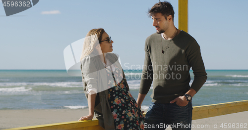 Image of Couple chating and having fun at beach bar