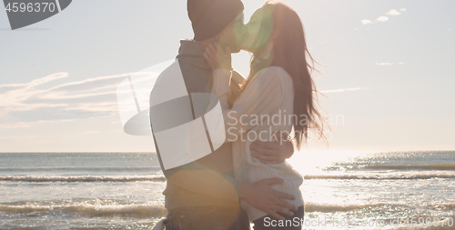 Image of Couple having fun on beautiful autumn day at beach