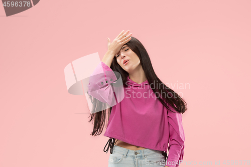 Image of Beautiful woman looking suprised and bewildered isolated on pink