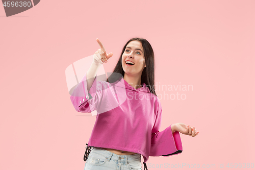 Image of Beautiful woman looking suprised isolated on pink