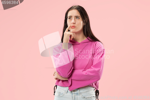 Image of Young serious thoughtful business woman. Doubt concept.
