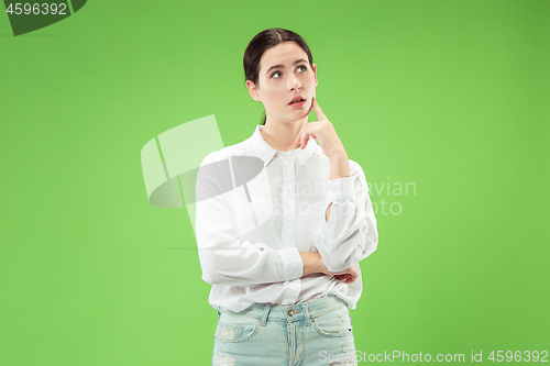 Image of Young serious thoughtful business woman. Doubt concept.