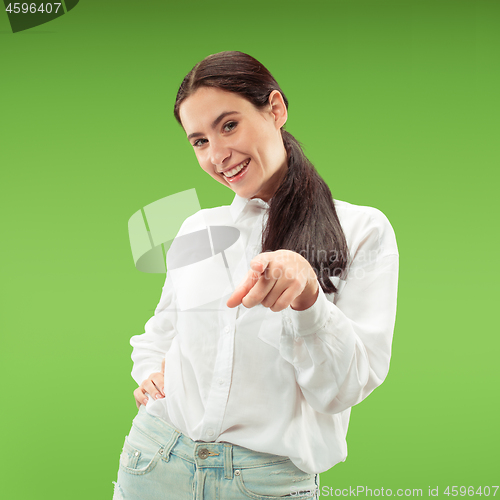 Image of The happy business woman point you and want you, half length closeup portrait on green background.