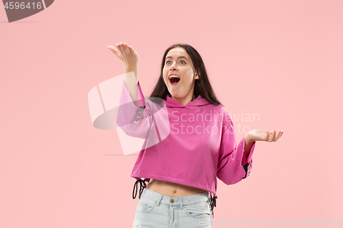 Image of Beautiful woman looking suprised isolated on pink