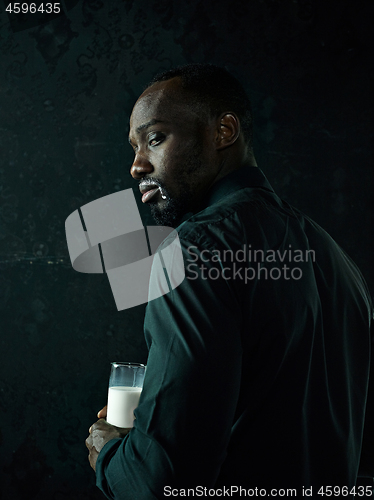 Image of Healthy young african man holging milk