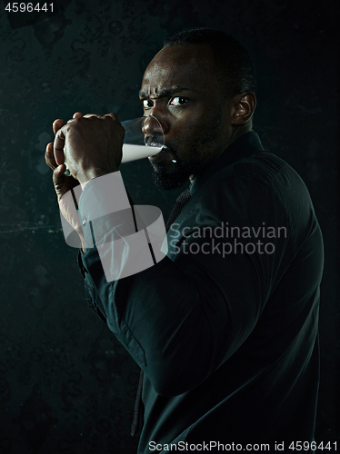 Image of Healthy young african man holging milk