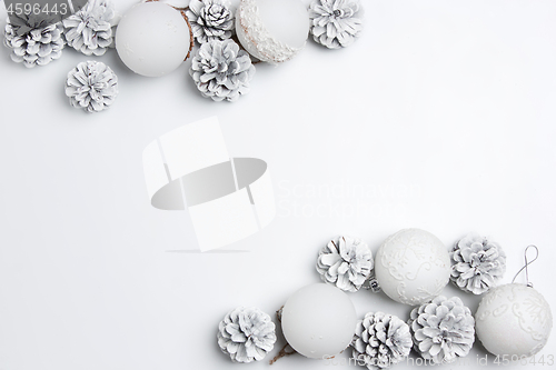 Image of Christmas decorative composition of toys on a white background surrealism. Top view